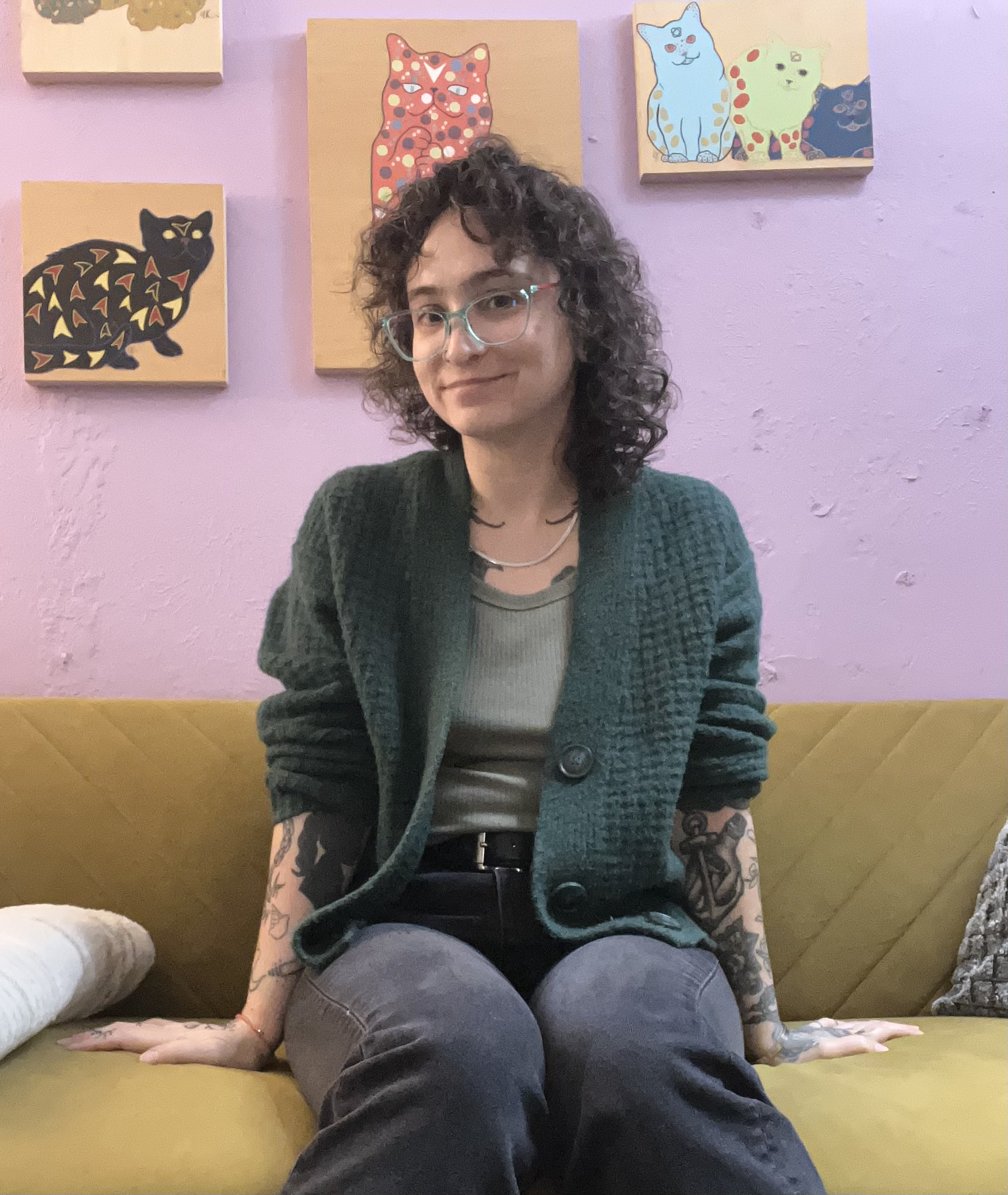 Riss Koupf LCSW sitting on a green couch